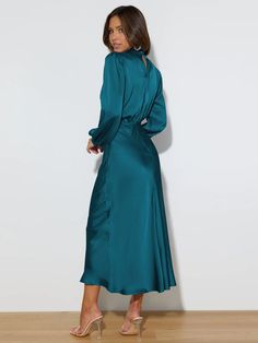 Make a statement in this FROM THE SOURCE High Neck Bridal Maxi Dress in an elegant teal! This stunning satin dress will make waves as you walk down the aisle and beyond. Dare to be bold and defy expectations with this daring wedding guest style dress. Stand out! Size Guide: Model is 5’7” tall, and has a 33.4” bust, 26.5” waist, & 34.6” hips. She is wearing a S / US 4 / AU 8. This dress is true to size. Material: 100% Polyester. Feature: High Neckline. Long Sleeve. Flowery Skirt. Elastic Waist. Maxi Length. Care Instructions: Machine wash / Cold hand wash Satin Midi Dress For Wedding, Solid Satin Midi Dress For Wedding, Wedding Midi Dress With Satin Finish, Green Satin Midi Dress For Bridesmaids, Elegant Turquoise Floor-length Dress, Green Satin Bridesmaid Midi Dress, Elegant Turquoise Maxi Dress For Party, Elegant Fitted Turquoise Maxi Dress, Elegant Turquoise Maxi Dress