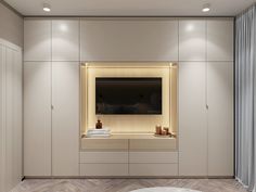 an empty room with white walls and wooden flooring is lit by recessed lighting