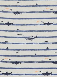 a blue and white striped fabric with sharks in the ocean on it's side