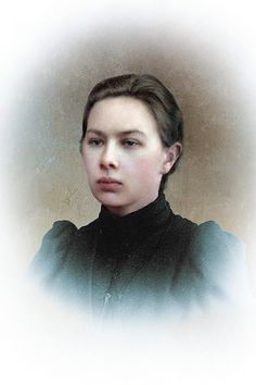 an old photo of a young woman in black clothes and a collared shirt, looking at the camera