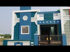 a blue and white building with a clock on it's front door is shown