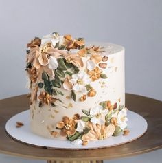 there is a white cake with flowers on it