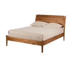 a wooden bed with white sheets and pillows