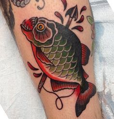 a person with a tattoo on their arm and an image of a fish in the background