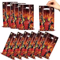 six bags with deadpool on them are being held up by someone's hand