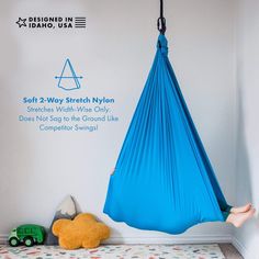 there is a blue hammock hanging from the wall next to a teddy bear