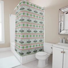 a bathroom with a toilet, sink and shower curtain in it's center area