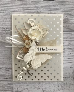 a card with some flowers on it and the words we love you written in white