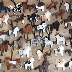 many different types of horse hair clips on a wooden surface with polka dots and black spots