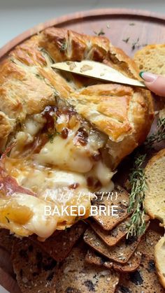 a plate with bread, crackers and pizza on it that says baked brie