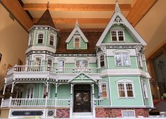 a large doll house is on display in a room