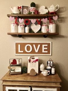 two shelves with love signs and other items on them