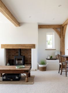 a living room filled with furniture and a fire place in the middle of a room