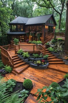 a wooden deck surrounded by lush green plants and trees with steps leading up to the house