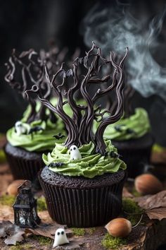 cupcakes decorated with green frosting and spooky trees