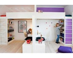 two girls are playing in the lofted room with bunk beds and bookshelves