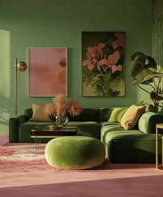 a living room with green walls and pink rugs on the floor in front of a large painting