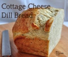 a loaf of bread sitting on top of a cutting board next to a knife