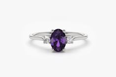 "Amethyst Ring / Amethyst Engagement Ring in 14k Gold / Oval Cut Natural Amethyst Diamond Ring / February Birthstone / Promise Ring by Ferkos Fine Jewelry Features ✔ Made to Order ✔ Gold Kt: 14K (also available in 18K) ✔ Available Gold Color: Rose Gold, Yellow Gold, White Gold ✔ Oval Amethyst: 1 pc 6x4MM ✔ Round Diamond: 2 pcs 2.0 MM ✔ Number of Stones: 3 ✔ Amethyst CTW: 0.72 ctw ✔ Diamond CTW: 0.06 ctw ✔ Ready to Ship in 7-10 Business Days Be sure to hit \"favorite\" on the right so it remains Birthstone Promise Rings, 3 Stone Ring, Amethyst Ring Engagement, Amethyst And Diamond Ring, 3 Stone Rings, Sapphire Diamond Ring, Sapphire Engagement, February Birth Stone, Multi Stone Ring