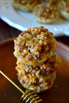 three cookies stacked on top of each other next to a plate with two forks in front of them