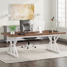 an office desk with a chair and laptop on it in front of a large window