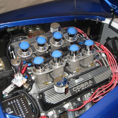 the engine compartment of a blue sports car