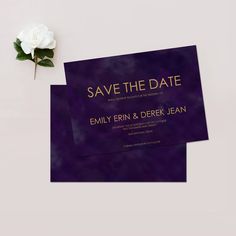 two purple and gold wedding save the date cards with a single white flower on top