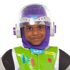 a young boy wearing a buzz lightyear costume and helmet with headphones on his ears