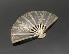 "SIAM 925 Sterling Silver - Vintage Niello Enamel Hand Fan Brooch Pin - BP6528  SIAM 925 Sterling Silver - Vintage Niello Enamel Hand Fan Brooch Pin - BP6528  Jewelry Type:         Brooch Pin   Metal Type:            925 Silver  Metal Size:             2.5\"  Stone Type:            N/A  Condition:              N/A  Jewelry Weight:     10.9 Grams  PLEASE NOTE: THIS ITEM IS PRE-OWNED. ALTHOUGH MOST ITEMS ARE IN VERY GOOD CONDITION, SOME MAY NEED CLEANING AND/OR MINOR REPAIRS. WE MAKE A VERY STRONG Hand Fan, Beautiful Rings, Types Of Metal, Brooch Pin, Brooches, Metallic Silver, 925 Silver, Size 2, Handmade Items