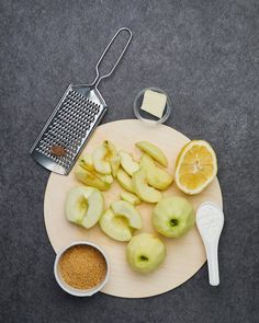 sliced apples on a cutting board with grater and sugar