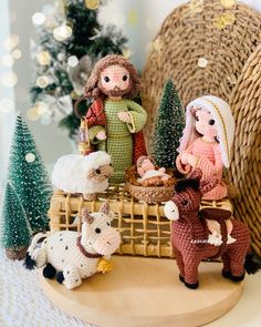 a nativity scene with figurines and christmas trees