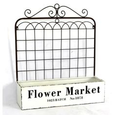 a flower market sign sitting on top of a white box