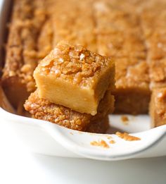 two pieces of cake sitting in a white dish