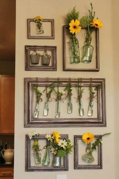 some vases with flowers are hanging on the wall