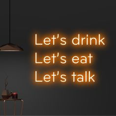 a neon sign that says let's drink let's eat let's talk