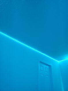 a room with blue walls and lights on the ceiling