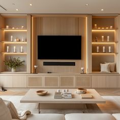 a living room filled with furniture and a flat screen tv mounted to the side of a wall