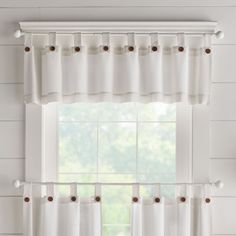 a window with white curtains in front of it