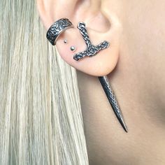 These Celtic Sword Earrings bring a unique look to any style. They are made of stainless steel, making them durable and perfect for everyday wear. The viking-style design gives a powerful statement look. Sold as SINGLE or PAIR Material : 316 Stainless steel Post: 0.9mm thick, 6mm long Size: 53 mm longed to edge. Blade:31 mm long Closure: Screw back Ships in a gift box Listing for sword earring only, cuff is not included Commemorative Jewelry, Dagger Earrings, Edgy Earrings, Celtic Earrings, Ear Jacket Earring, Gothic Earrings, Estilo Boho Chic, Traje Casual, Viking Jewelry