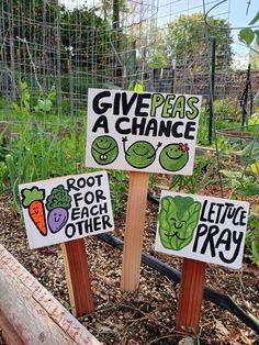 three signs that say give peas a chance, root for each other and lettuce pray