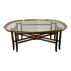 an oval glass table with bamboo legs