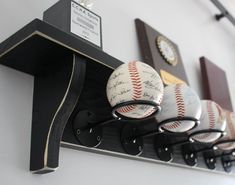 several baseballs are hanging on the wall