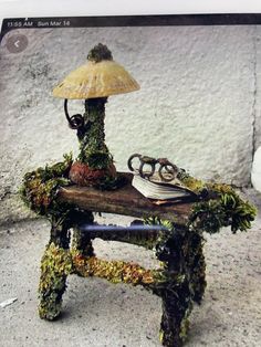 an old fashioned lamp with moss growing on it's sides and a shoe under the shade