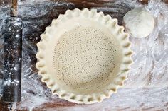 an uncooked pie crust next to a pastry knife