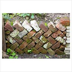 an old brick wall with moss growing on it