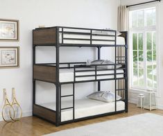 a bunk bed with two sets of mattresses on top of it in a room