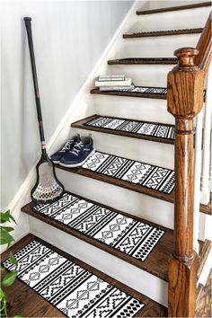 the stair treads are decorated with black and white geometric designs, along with a rubber mop