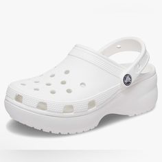 Platform Shoes For Women: Reach New Heights With These Platform Crocs For Women. They Feature The Comfort And Style You Love About The Regular Classic Clogs, Plus A 1.6-Inch Platform Sole All The Way Around. Fun Platform Crocs: These Are The Crocs Women Need And They Come In A Range Of Colors. The Crocs Classic Platform Clogs Are Incredibly Lightweight And Fun To Wear. Comfortable And Lightweight: Crocs Platform Clogs For Women Have The Iconic Crocs Comfort Technology, Made For Flexibility And 3 Crocs White Platform, Platform Crocs, Classic Icon, Bday List, Crocs Fashion, College List, Clogs Style, Platform Clogs, Women's Crocs