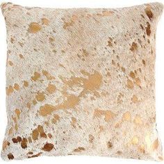 an animal print pillow with gold spots on the front and back, against a white background