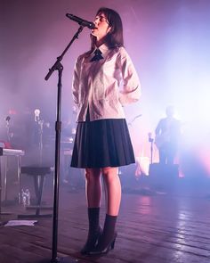 a woman standing in front of a microphone